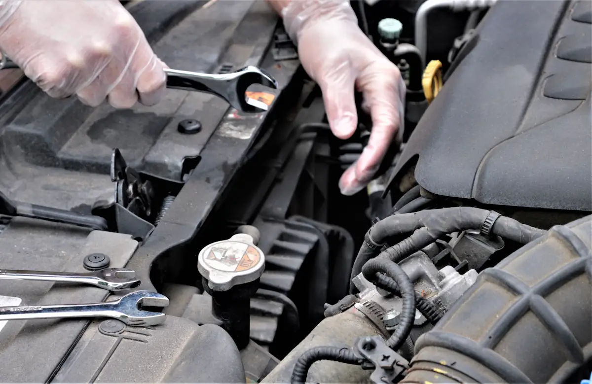 Une personne qui change le courroie d'une clio